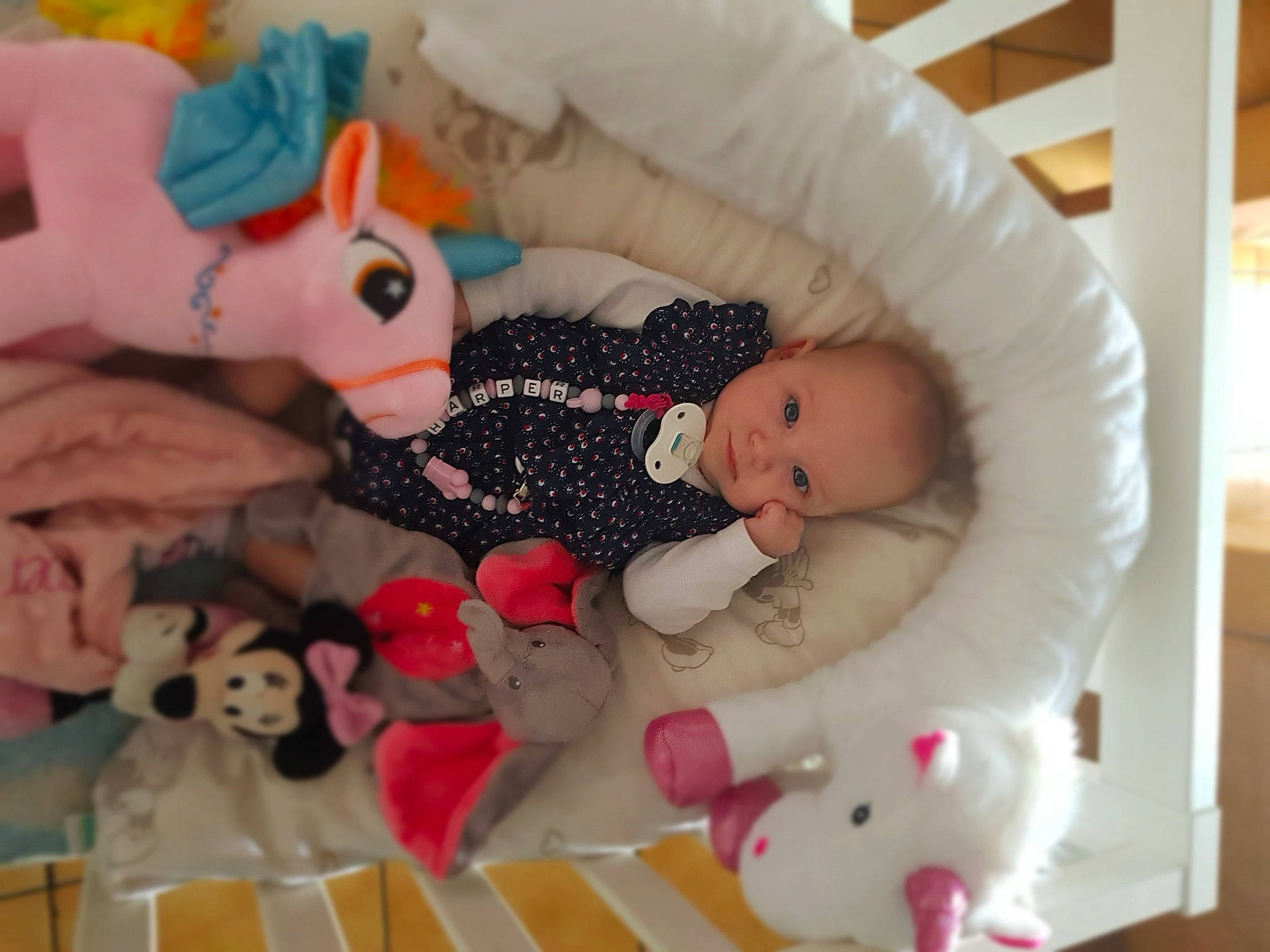 Harper a rejoint le concours — aidez-le/la à gagner de superbes lots ! baby, baby_products, baby_toys, bed, bedtime, cheek, child, doll, fawn, furniture, infant_bed, person, pink, product, room, skin, sleep, stuffed_toy, toy