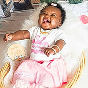 Kahlani is registered to the contest to win money with this photo: baby, girl, smiling, laughing, basket, pink_skirt, white_shirt, bracelets, necklace, bow, fluffy_blanket, wooden_sign, easter, flowers, watering_can, plants, indoors, cute, happy, portrait