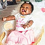 baby, girl, smiling, laughing, basket, pink_skirt, white_shirt, bracelets, necklace, bow, fluffy_blanket, wooden_sign, easter, flowers, watering_can, plants, indoors, cute, happy, portrait
