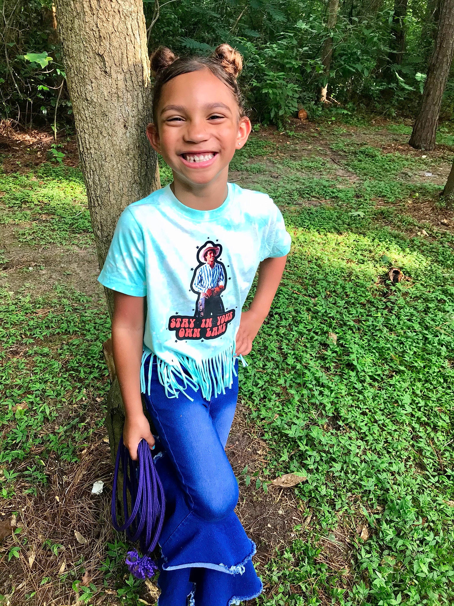 Dallas is registered to the contest to win money with this photo: baby_toddler_clothing, cool, electric_blue, face, grass, green, hair, happy, head, joy, leisure, natural_environment, people_in_nature, person, plant, shoulder, sleeve, smile, t_shirt, toddler