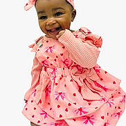 Khwezi joined the competition — help win amazing prizes! child, baby, smile, headband, bow, pink_dress, heart_pattern, long_sleeves, knitted_sleeves, sitting, bare_feet, toes, closeup, portrait, studio_background, accessory, happy, dark_hair, eyes, cheerful