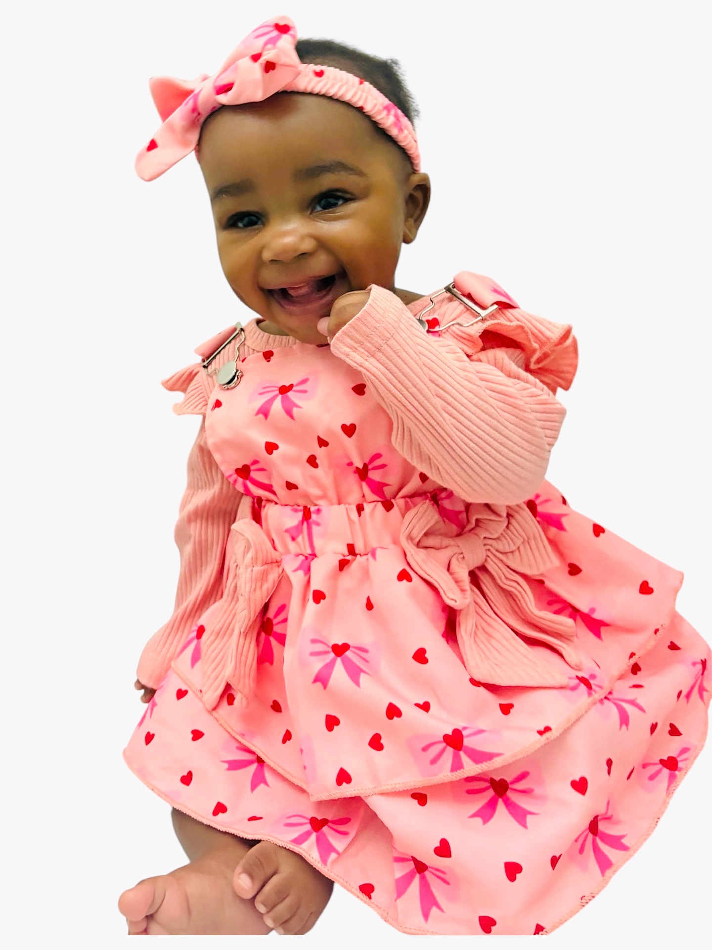 Khwezi joined the competition — help win amazing prizes! child, baby, smile, headband, bow, pink_dress, heart_pattern, long_sleeves, knitted_sleeves, sitting, bare_feet, toes, closeup, portrait, studio_background, accessory, happy, dark_hair, eyes, cheerful