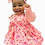 Khwezi joined the competition — help win amazing prizes! baby, infant, child, smiling, pink_dress, headband, bow, happy, portrait, plain_background, eyes, teeth, raised_hand, sitting, bare_feet, clothing, adorable, toddler, playful, accessory