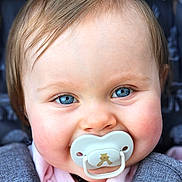 Indigo joined the competition — help win amazing prizes! baby, blue_eyes, pacifier, face, child, cute, infant, portrait, close_up, clothing, warm, pink, gray, skin, hair, expression, adorable, young, person, smile