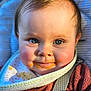 Indigo is registered to the contest to win money with this photo: baby, bib, blue_eyes, close_up, cute, face, feeding, food_stains, infant, light, natural_light, pink_cheeks, portrait, rosy_cheeks, smile, soft_texture, straps, toddler, wearing, young_child