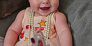 Indigo is registered to the contest to win money with this photo: baby, blue_eyes, child, couch, cozy, cute, dress, happy, headband, indoor, infant, pearl_necklace, person, pink, portrait, sitting, smiling, soft_toys, tutu, wand