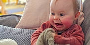 Indigo is registered to the contest to win money with this photo: baby, blanket, child, clothing, comfort, couch, cozy, cute, face, happy, home, indoor, infant, pillow, relaxed, sitting, smiling, soft, warm, young