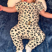 Yasmin is registered to the contest to win money with this photo: baby, sleeping, infant, pillow, blanket, headband, leopard_print, clothing, soft_texture, cute, peaceful, resting, young_child, indoor, portrait, white_socks, cozy, comfort, child, toddler