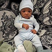 Jacai joined the competition — help win amazing prizes! baby, infant, child, calvin_klein, hat, socks, knitted_blanket, patterned_background, paisley, blue_clothing, soft_texture, cute, portrait, indoors, sitting, furniture, cozy, young_child, looking_at_camera, person