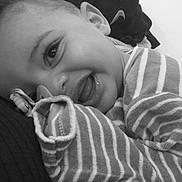 Kingsley participe au concours pour gagner de l'argent avec cette photo : baby, smiling, face, closeup, striped_clothing, infant, cute, happy, portrait, child, black_and_white, cozy, soft_texture, person, head, eyes, mouth, sleeves, lying_down, expression