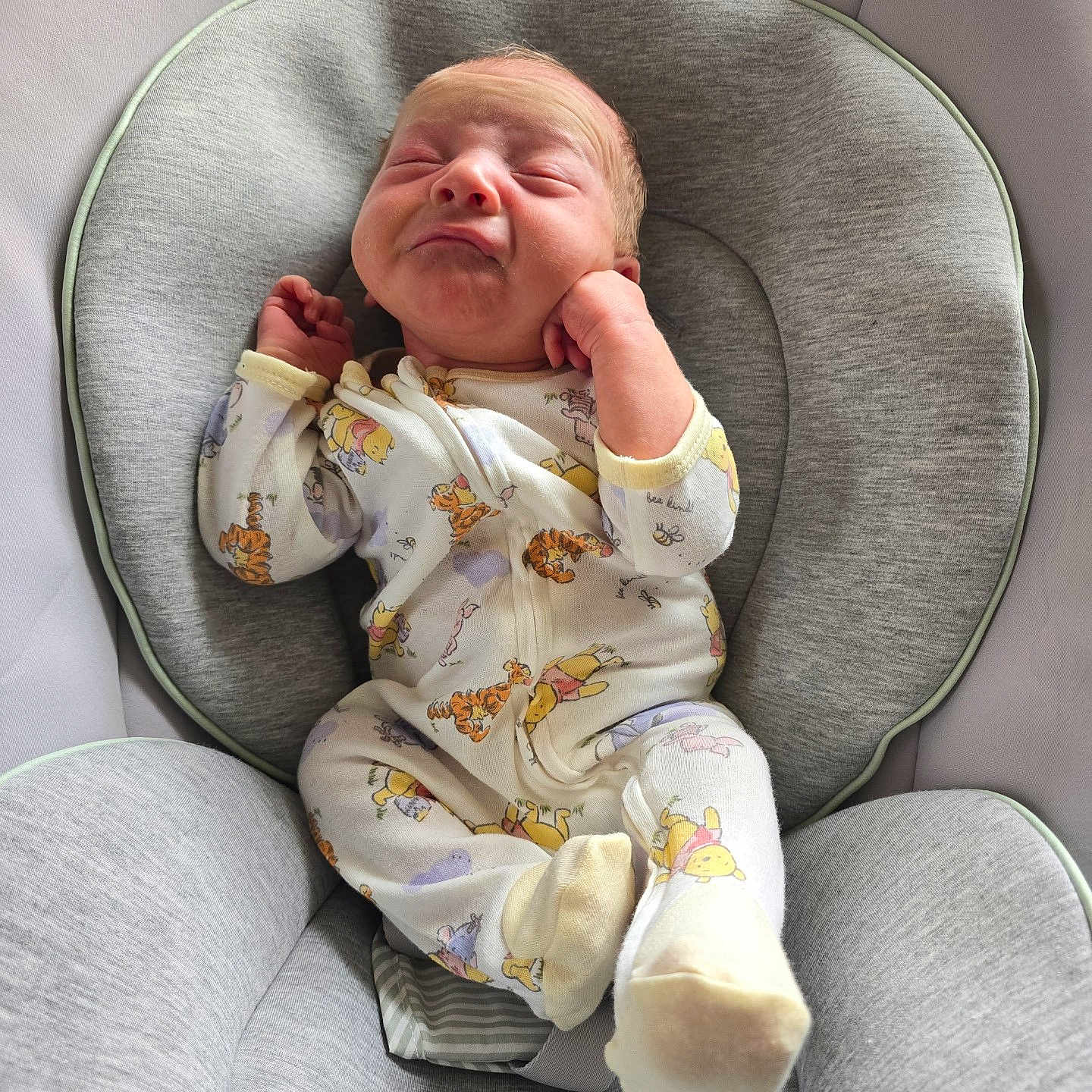 Coleson joined the competition — help win amazing prizes! baby, infant, child, pajamas, winnie_the_pooh, onesie, baby_seat, gray, plush, comfortable, face, expression, hands, feet, indoors, soft_lighting, cute, sleepwear, newborn, portrait