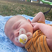 Kobe joined the competition — help win amazing prizes! baby, blanket, child, clothing, face, grass, head, infant, knitted, nature, orange, outdoor, pacifier, park, peaceful, playground, relaxation, sleeping, slide, striped