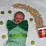 baby, newborn, infant, face, swaddle, green_bow, bow_tie, lucky_charms, cereal, marshmallows, clover, shamrock, st_patricks, blanket, white_background, cup, props, holiday, festive, cute