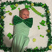 Nolan Keith is registered to the contest to win money with this photo: baby, infant, newborn, bow_tie, green_decor, st_patricks, shamrock, leprechaun_hat, garland, swaddle, blanket, portrait, lying_down, festive, holiday, cute, decoration, eyes_open, face, adorable