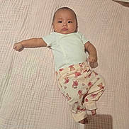 Avery joined the competition — help win amazing prizes! baby, infant, child, lying_down, blanket, clothing, white_shirt, patterned_pants, elephant_pattern, cute, soft_texture, indoors, portrait, one_arm_stretched, feet, head, face, expression, newborn, comfortable