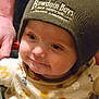 Able joined the competition — help win amazing prizes! baby, child, face, beanie, hat, clothing, hand, person, indoor, cute, smile, patterned_clothing, infant, young_child, portrait, warm_clothing, support, close_up, expression, headwear