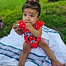 baby, child, infant, girl, outdoor, grass, blanket, sitting, cute, red_clothing, minnie_mouse, hair_clips, fingers_in_mouth, portrait, happy, summer, playful, innocent, park, young