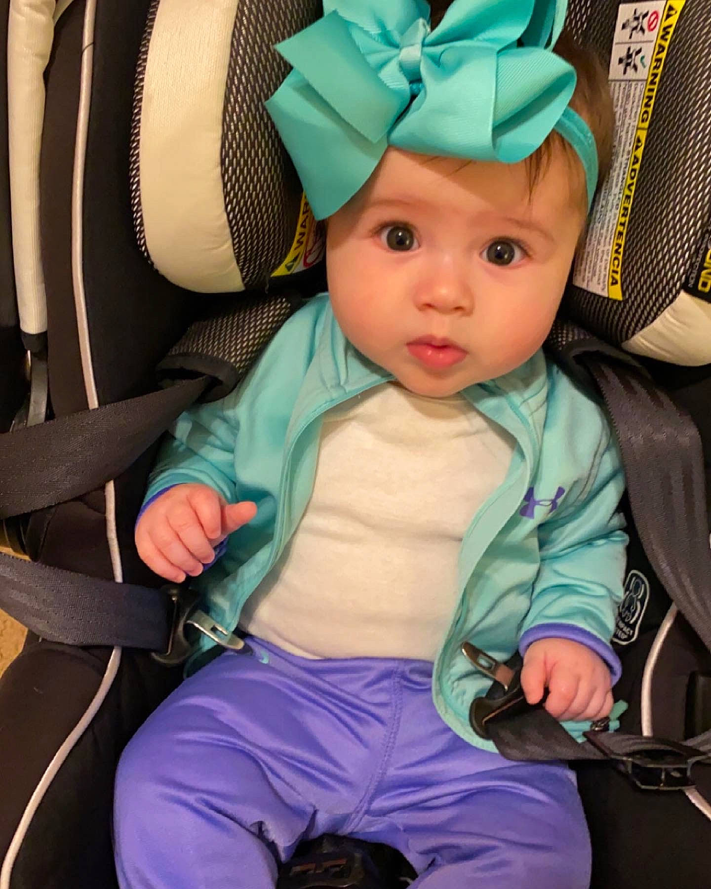 Emilia is registered to the contest to win money with this photo: baby, baby_carriage, baby_toddler_clothing, beauty, blue, cap, car_seat, cheek, child, comfort, costume_hat, headwear, helmet, organ, person, pink, product, purple, skin, toddler
