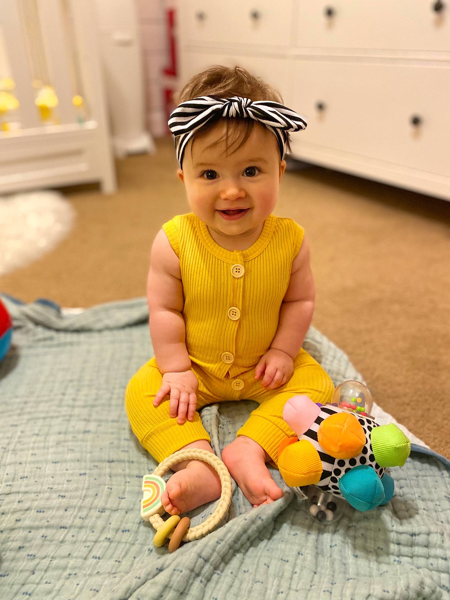 Emilia joined the competition — help win amazing prizes! baby, baby_toddler_clothing, child, costume, eye, face, fashion_accessory, flooring, fun, grass, happy, headwear, human_leg, joy, leisure, person, play, sandal, sitting, skin
