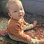 Simon is registered to the contest to win money with this photo: baby, casual, child, couch, cozy, curious, face, foot, furniture, hand, home, indoor, pants, patterned_rug, portrait, rug, sitting, soft_light, sweater, young