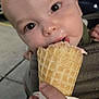 Simon is registered to the contest to win money with this photo: baby, child, ice_cream, cone, hand, outdoor, night, close_up, face, licking, sweet, food, dessert, curious, cute, person, skin, head, eyes, mouth