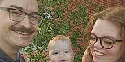 Simon joined the competition — help win amazing prizes! adult, baby, bench, brick_wall, casual_clothing, child, daylight, family, father, glasses, greenery, happy, mother, nature, outdoor, parent, people, portrait, smile, toddler