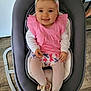 baby, infant, smiling, pink_clothing, headband, baby_rocker, shoes, tights, child, cute, happy, indoor, flooring, wood_floor, seat, person, portrait, playful, home, young_child