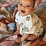 baby, child, smiling, happy, cute, sitting, shirt, fabric, quilt, bed, indoors, portrait, infant, toddler, clothing, face, skin, hand, eyes, expression