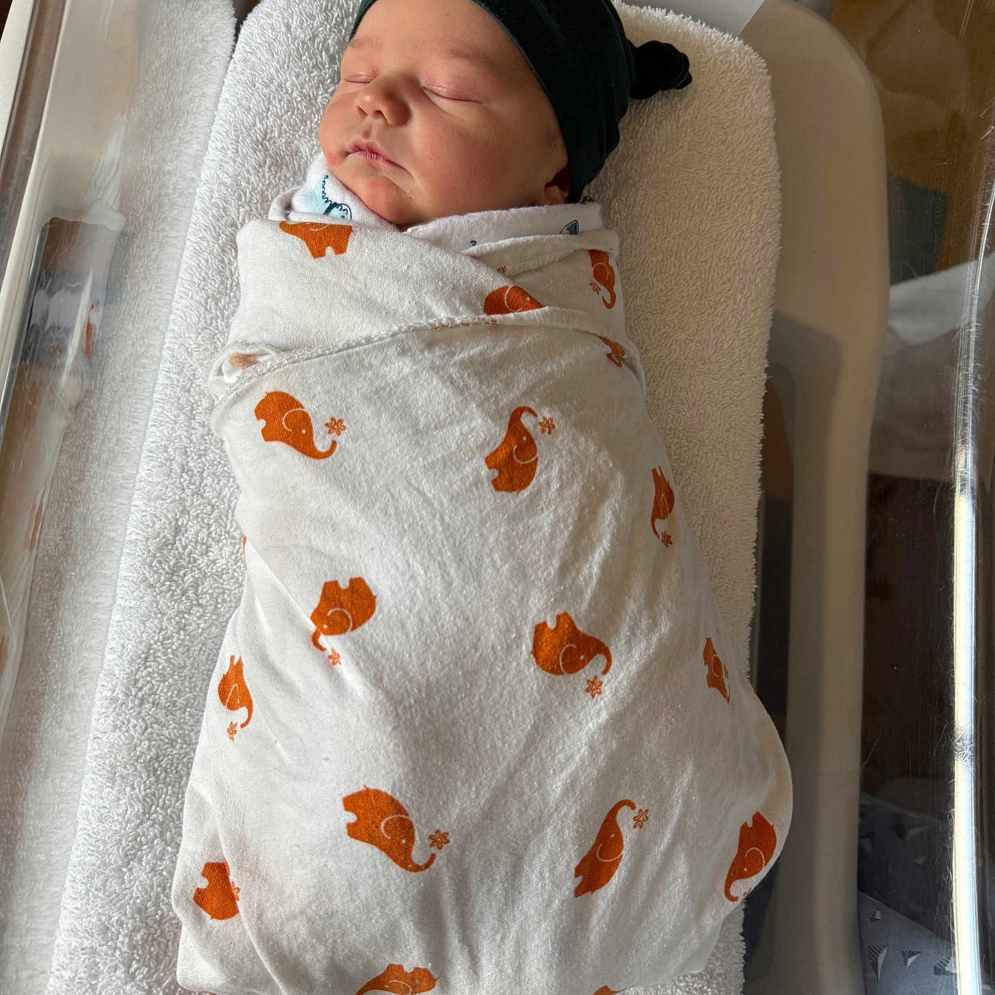 Winslow is registered to the contest to win money with this photo: baby, bed, blanket, cradle, crib, face, furniture, head, infantbed, newborn, person, sleeping, towel