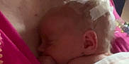 Paisley joined the competition — help win amazing prizes! adult, baby, blanket, care, closeup, comfort, ear, face, family, head, holding, indoor, love, newborn, person, pink_clothing, resting, skin, sleeping, tender