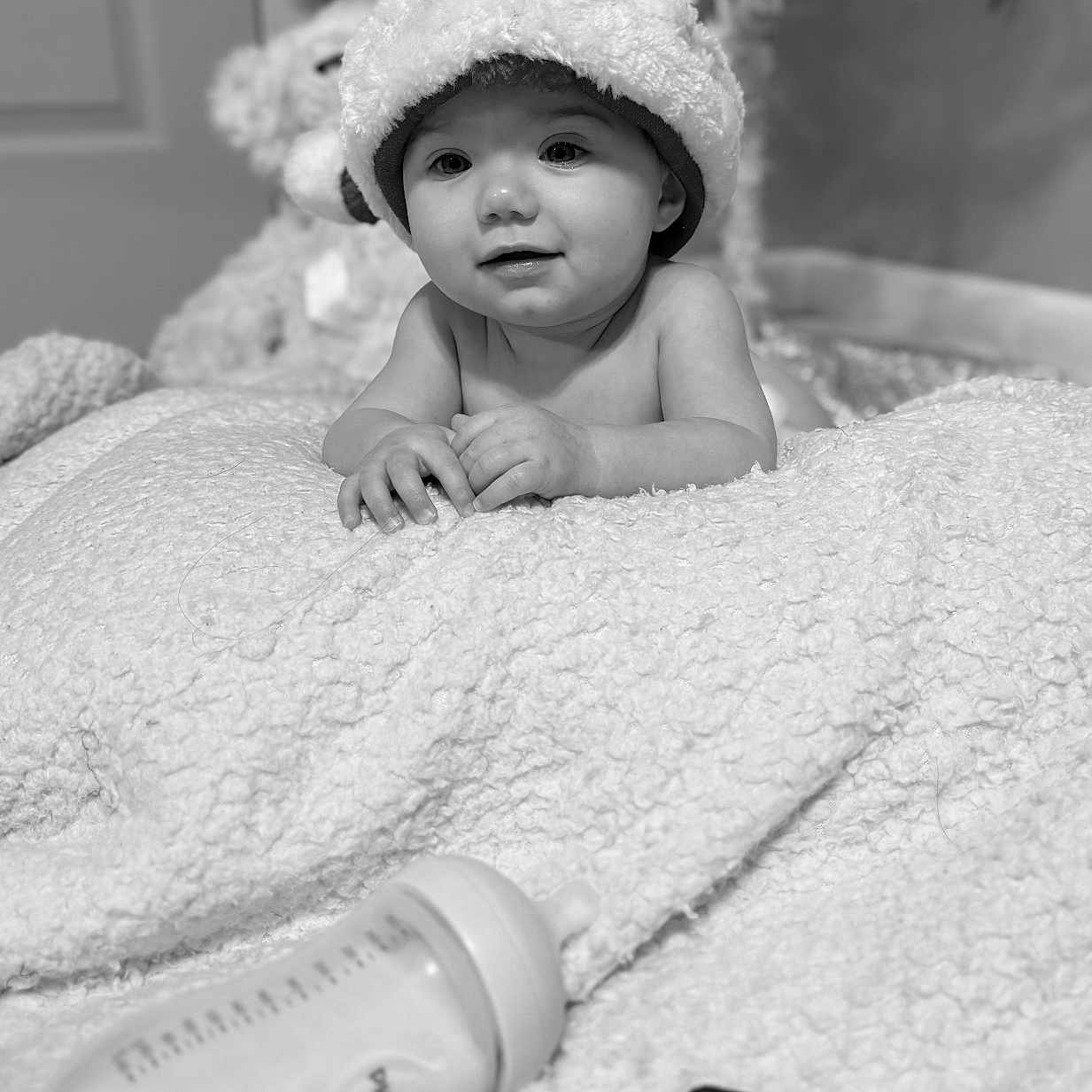 Selena is registered to the contest to win money with this photo: baby, black_and_white, blanket, bottle, child, christmas_tree, cookies, cozy, cute, face, floor, hands, holiday, indoors, infant, portrait, santa_hat, smiling, soft_lighting, toys