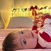 Selena joined the competition — help win amazing prizes! baby, bed, blanket, child, clothing, face, furniture, headboard, holiday, indoor, light, lighting, person, pillow, red, sheet, toy, white, young_child, decor