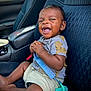 Auguste joined the competition — help win amazing prizes! baby, child, car_seat, pacifier, blue_pacifier, smiling, happy, infant, clothing, tshirt, shorts, car_interior, seat, sitting, hand, face, portrait, young_child, cute, expression