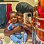 baby, adult, mirror, bathroom, selfie, smiling, pajamas, toiletries, towels, sink, phone, reflection, happy, person, holding, child, clothing, face, indoor, family