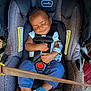baby, car_seat, sleeping, child, infant, blue_shoes, clothing, harness, safety, cute, peaceful, small_hand, casual_wear, indoors, comfort, resting, seatbelt, head_support, portrait, smile