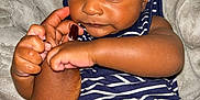 Auguste is registered to the contest to win money with this photo: baby, infant, child, hand, striped_clothing, blue, white, skin, face, eyes, expression, holding, adult_hand, blanket, soft, closeup, portrait, cute, person, indoors