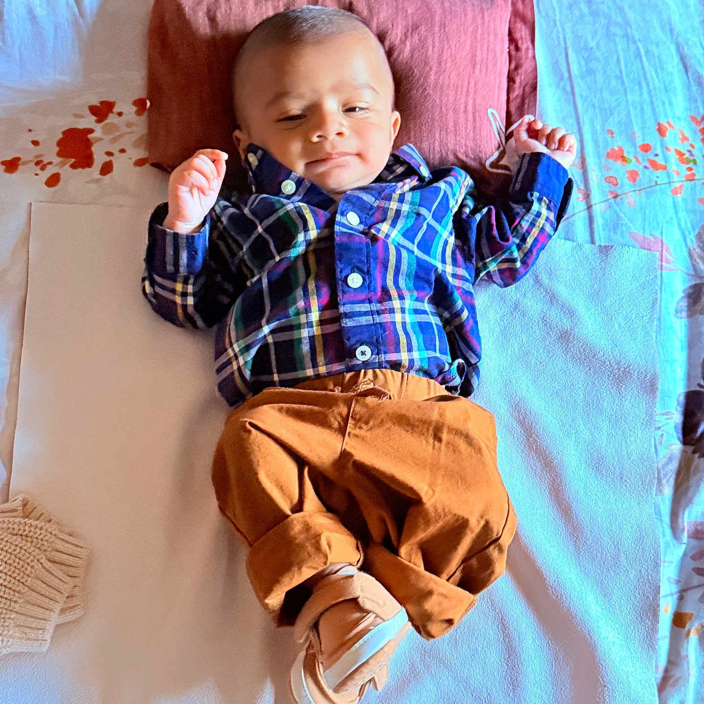 Trishiv is registered to the contest to win money with this photo: baby, bed, blanket, brown_pants, child, comfortable, cozy, cute, footwear, indoors, infant, person, pillow, plaid_shirt, portrait, relaxing, sleepwear, sleepy, smiling, young