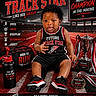 baby, child, track_star, athlete, trophy, sportswear, running_shoes, sports_bag, water_bottle, track_field, motivation, champion, training, determination, focus, legacy, portrait, sports_equipment, competition, future_star