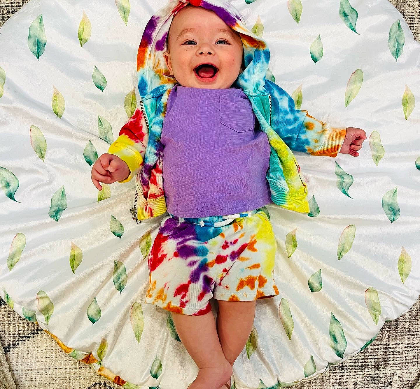 Avi is registered to the contest to win money with this photo: baby_toddler_clothing, child, dress, facial_expression, green, happy, headwear, human_body, outerwear, people_in_nature, person, pink, product, purple, shorts, sleeve, smile, t_shirt, textile, toddler