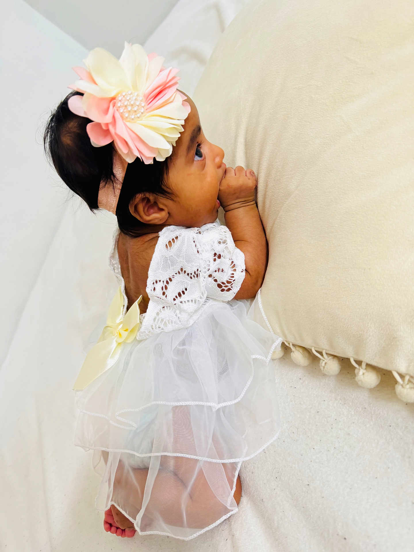 Jeevithapriya is registered to the contest to win money with this photo: baby, infant, child, dress, lace, flower_headband, thumb_sucking, cute, soft_texture, cream_color, lying_down, small_feet, curious, indoors, portrait, adorable, toddler, sleepy, closeup, gentle