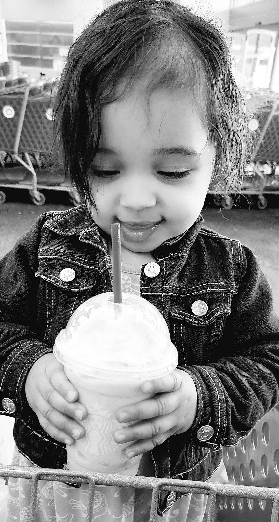 Gabriella is registered to the contest to win money with this photo: black, black_and_white, child, cool, drinkware, facial_expression, gesture, hairstyle, happy, monochrome, monochrome_photography, organ, people, person, photograph, sleeve, smile, standing, style, toddler