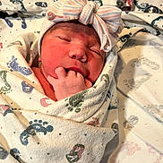 Lysandra joined the competition — help win amazing prizes! newborn, baby, infant, wrapped, blanket, footprint_pattern, hat, bow, sleeping, fingers_in_mouth, closeup, face, skin, cute, cozy, hospital_blanket, soft_lighting, peaceful, child, portrait