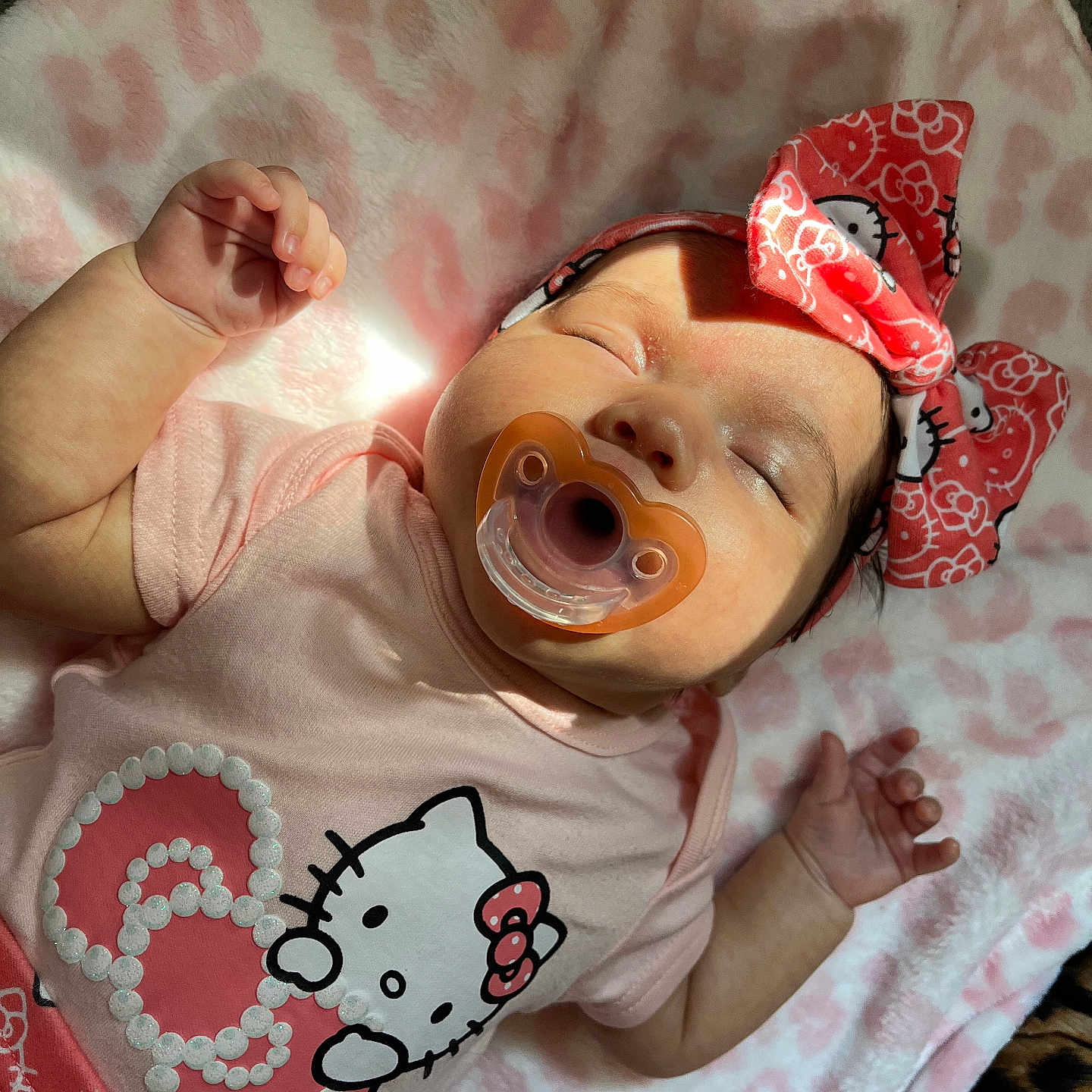 Lysandra is registered to the contest to win money with this photo: adorable, apparel, baby, blanket, child, clothing, cute, headband, heart_pattern, hello_kitty, indoor, infant, nap, pacifier, peaceful, pink, resting, sleeping, soft_texture, toddler