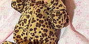 Lysandra is registered to the contest to win money with this photo: baby, blanket, child, cozy, cute, face, hand, indoor, infant, leopard_print, lying_down, newborn, onesie, pattern, person, pink, portrait, sleepwear, soft, stars