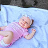 baby, infant, pink_onesie, headband, white_blanket, smiling, outdoor, playful, cute, child, young, lying_down, happy, skin, face, foot, hand, head, person, baby_girl