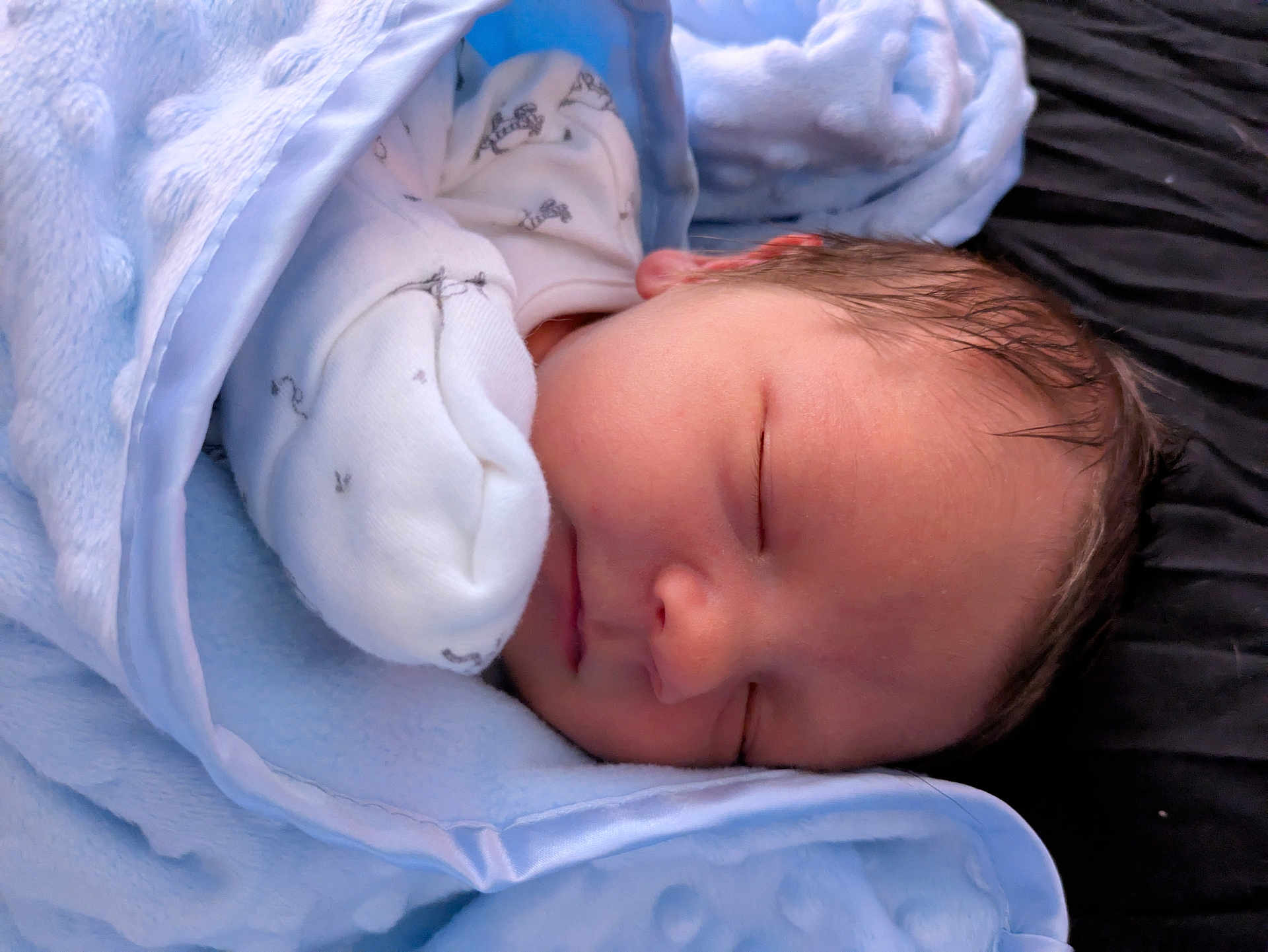 Wyatt is registered to the contest to win money with this photo: newborn, baby, sleeping, blanket, blue, soft, infant, peaceful, cute, face, closed_eyes, warm, cozy, rest, child, wrapped, bed, comfort, skin, portrait