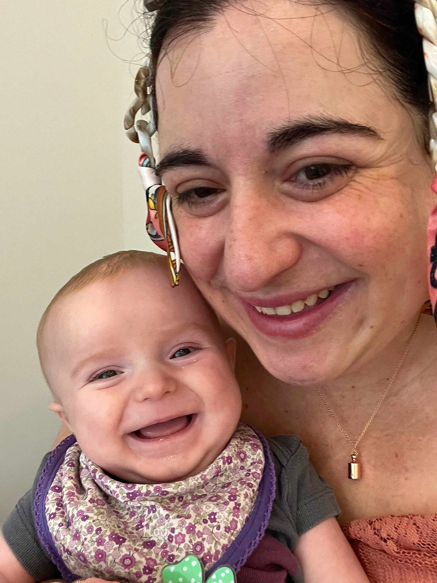 Björn participe au concours pour gagner de l'argent avec cette photo : baby, woman, smile, happy, face, headscarf, bib, portrait, closeup, joy, person, infant, clothing, accessory, necklace, skin, expression, cheerful, family, indoors