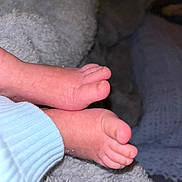 Noah is registered to the contest to win money with this photo: baby_feet, close_up, soft_texture, blanket, blue_sleeve, skin_detail, toes, infant, cozy, warm, resting, small, cute, sleeping_baby, newborn, fuzzy, comfort, indoor, peaceful, tender