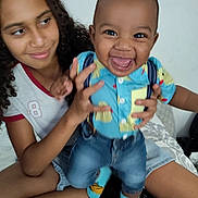 Avaughn is registered to the contest to win money with this photo: baby, bed, casual, child, clothing, curly_hair, cute, denim_shorts, fun, happy, holding, indoor, patterned_bedspread, person, playing, portrait, sibling, smile, socks, toddler