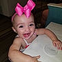 Charli is registered to the contest to win money with this photo: toddler, child, pink_bow, smiling, happy, table, indoor, person, face, arm, clothing, headband, expression, cute, baby, skin, furniture, tabletop, human, portrait